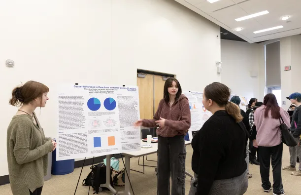 psychology students presenting at the NHCC+ event