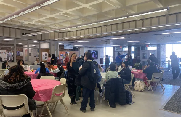 a photo of students gathering, sitting at tables and conversing at our Student Appreciation Day event in the Campus Center. 