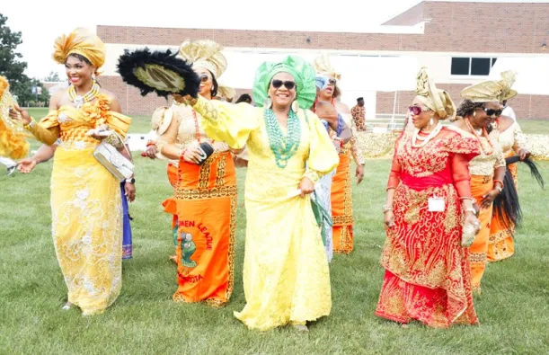 this is a photo of African women dressed in their cultural regalia, outside on the NHCC campus grass during their IgboFest Celebration event. 