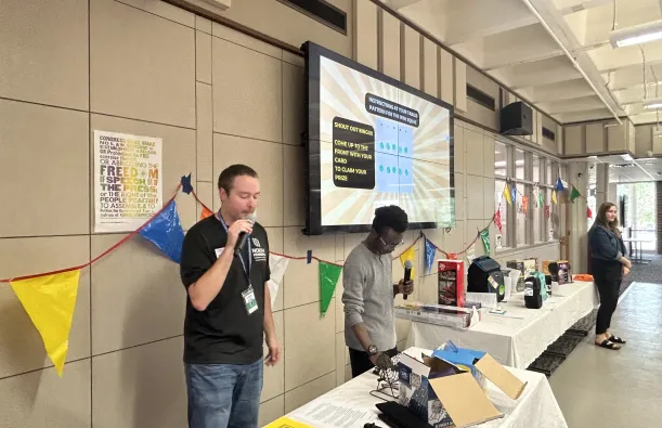 this is a photo of NHCC Student Life staff, calling bingo cards at an event in the Campus Center. 