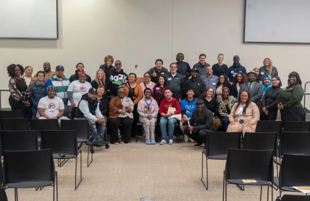this is a large smiling group photo of community and local partnerships, Brooklyn Park employees, the Mayor, NHCC alumni and local leaders together in Helling Hall on the stage posing for a photo at a Civic Engagement Series event we hosted in fall 2025. 