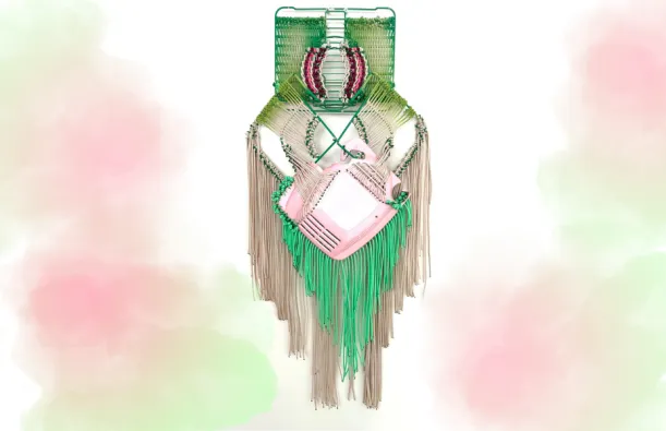 this is a photo of a handwoven green and pink macrame hanging art piece, created by artist, Liz Miller. 