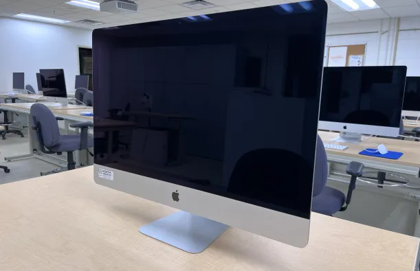 this is a photo of an iMac computer sitting on a desktop in a classroom on-campus. 