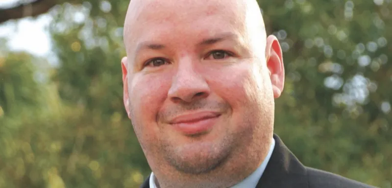 NHCC president Rolando Garcia standing outside smiling at the camera