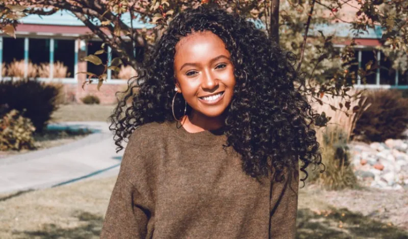 female student smiling outside