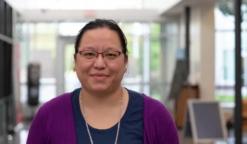 computer science student Lillian Ahles inside smiling and facing camera 