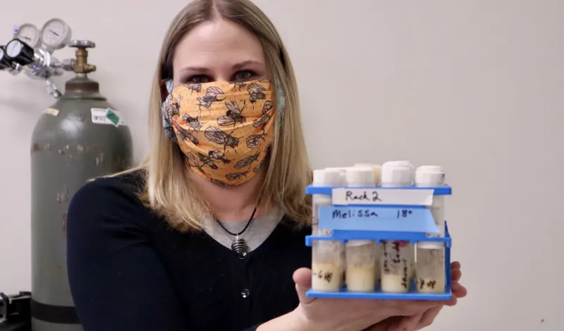 nursing student Melissa Sawyer holding up pack of vials for the camera