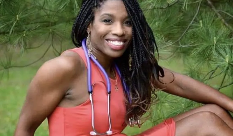 nursing alumni Jeanette Rupert posing for the camera outside below a pine tree