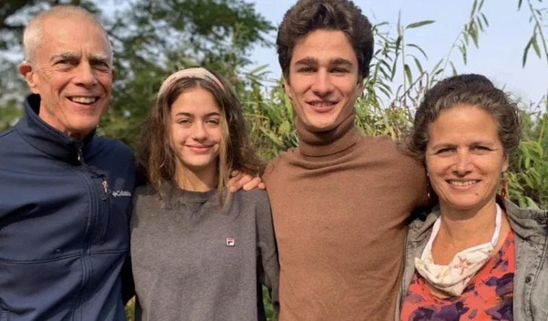 faculty member Patricia Diamond taking a picture with her daughter, son, and husband