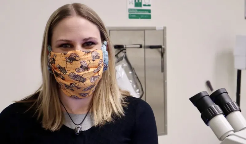 STEM student Melissa Sawyer pictured inside one of NHCC's labs with her mask on