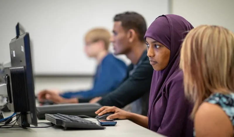 Students looking at computer