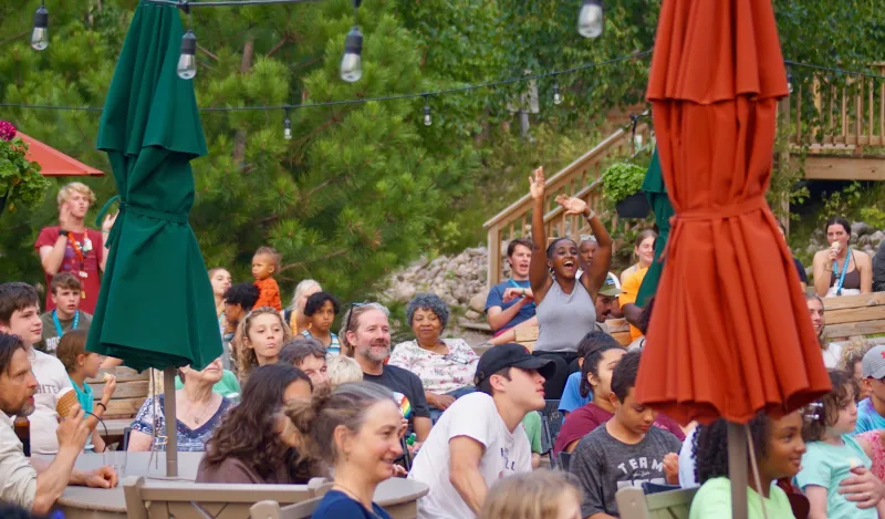 Photo of adults and young adults outside at summer camp