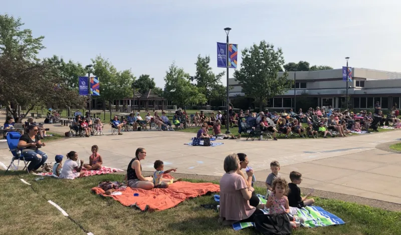 a photo of people in NHCC's courtyard during the summer