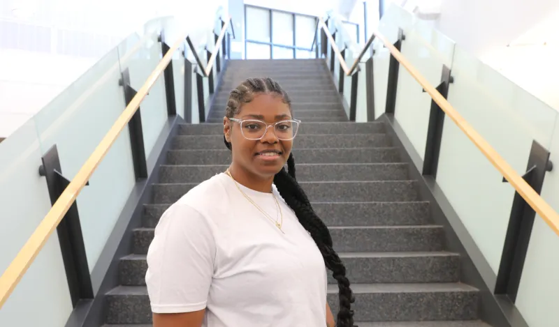 Photo of a female NHCC student near CBT staircase
