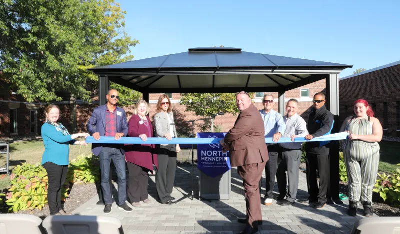 photo of former NHCC staff, NHCC Foundation staff, NHCC Foundation Board Members, NHCC President and an NHCC student cutting the ribbon at the Heritage Garden Dedication. 