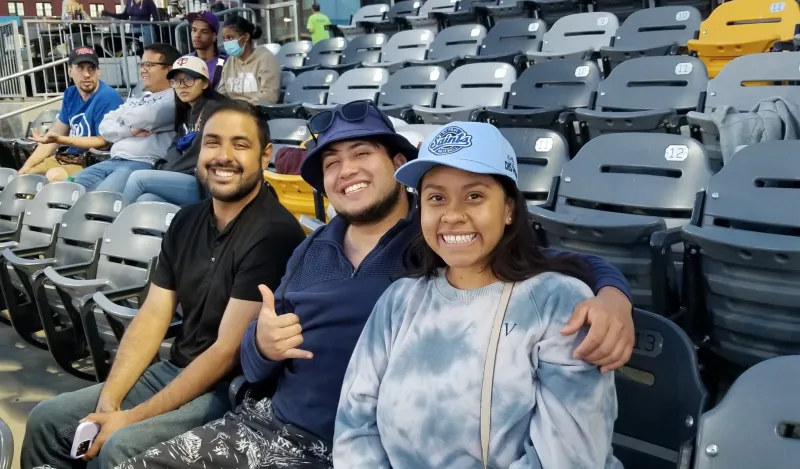 a group of NHCC alumni and friends at the Saints baseball game.