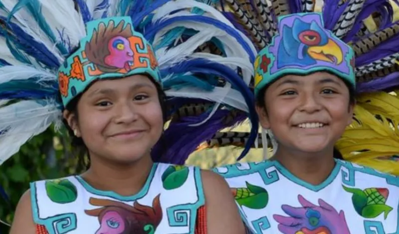 a photo of girls smiling from a Hispanic Heritage Month event flyer