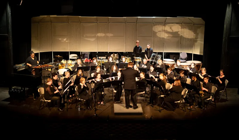 a concert band performing on stage 