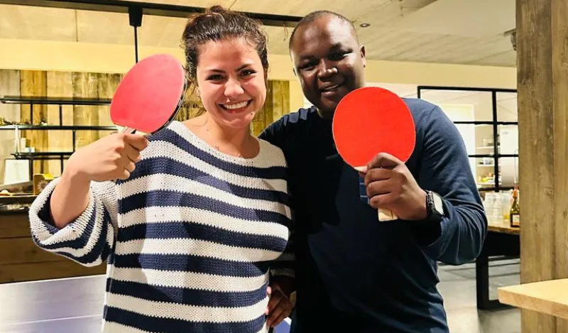 a photo of NHCC student, Donald Agik and his fellow student smiling with their paddles after playing ping pong