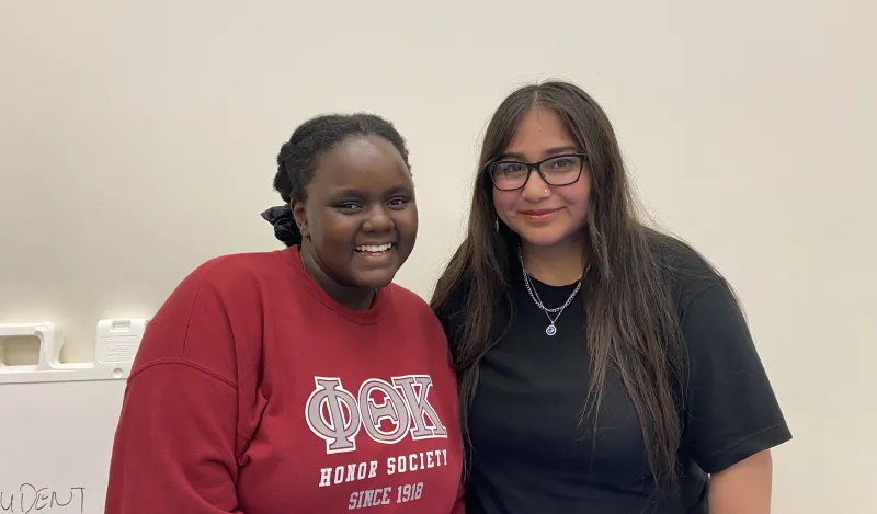 NHCC student, Hozea smiling with a friend 