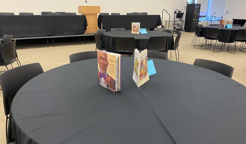 Books as table centerpieces at Why Teach event 