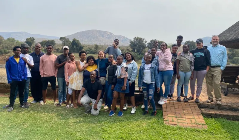 a group photo of students in Africa with NHCC faculty, Todd Johnson