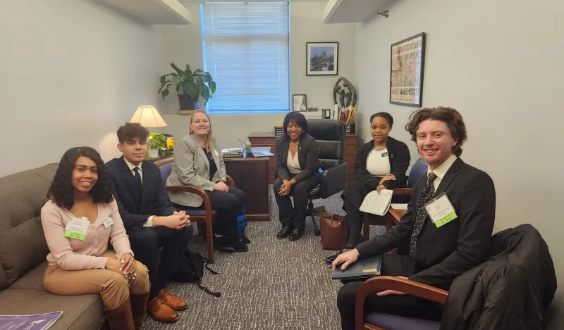a photo of Student Senators visiting with legislators at the MN State Capitol