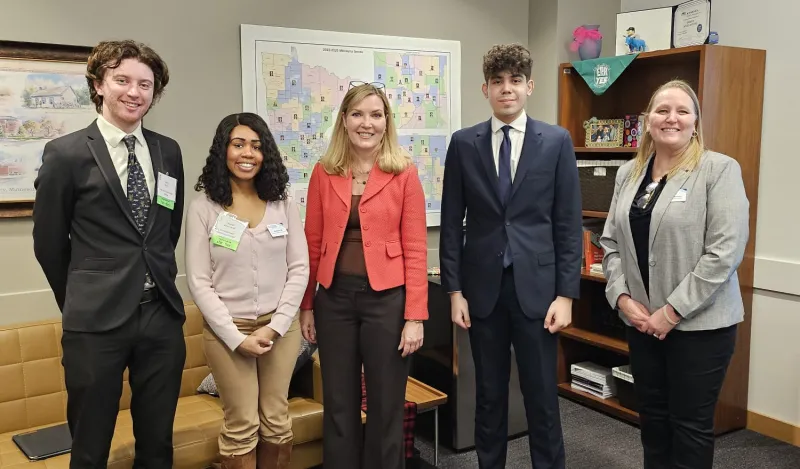 a photo of Student Senators visiting with legislators at the MN State Capitol