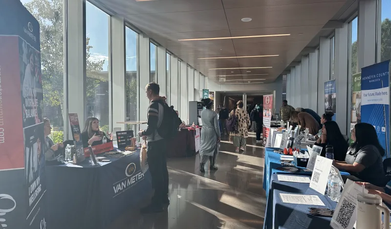 hallway during a career fair with tables and students wandering