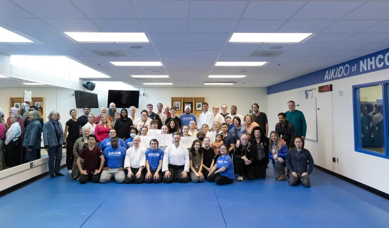 group of students and instructors in the aikido dojo 