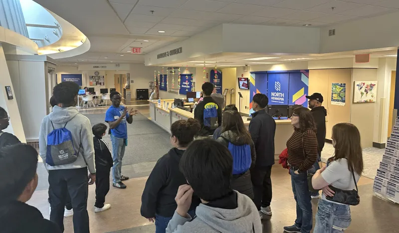 a group of people standing around listening to a tour guide