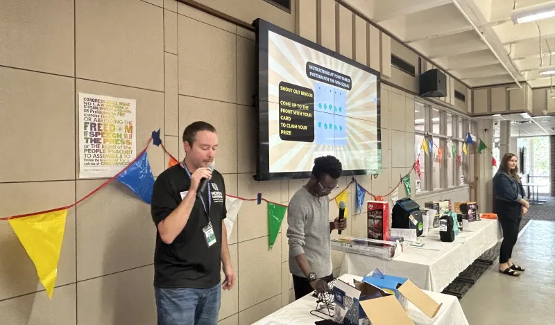 this is a photo of NHCC Student Life staff, calling bingo cards at an event in the Campus Center. 