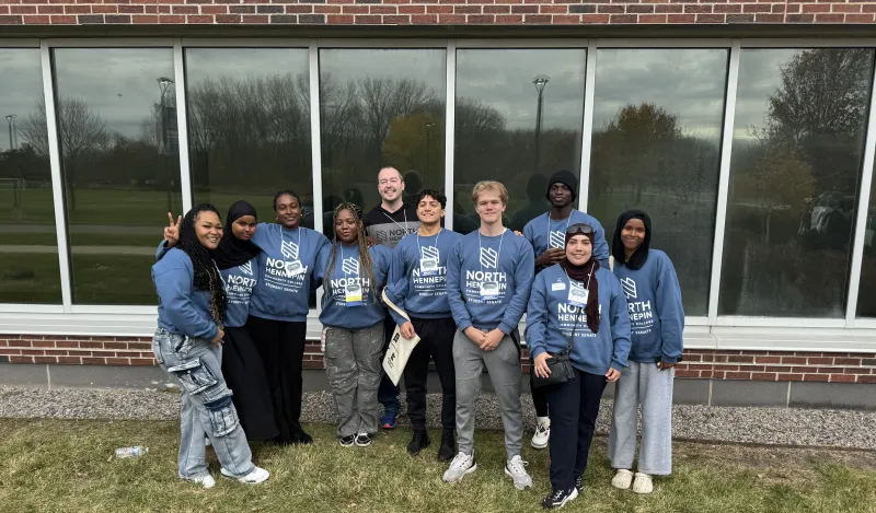 Group of Student Senators standing outside in front of a window