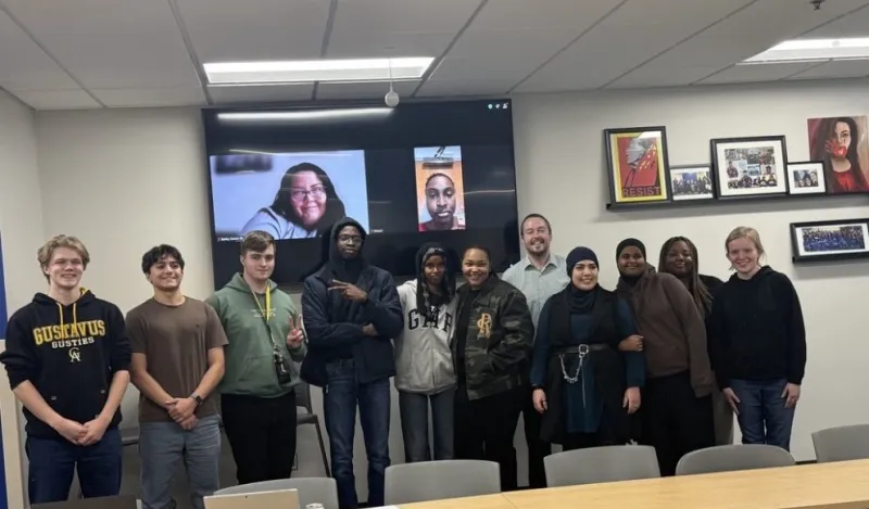 group of senators standing in a row, in front of a screen