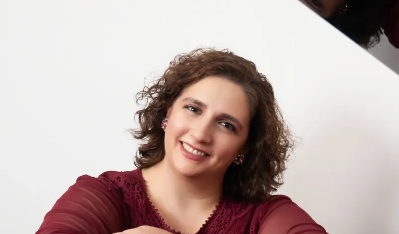 this is a headshot photo of a female jazz composer named, Kristin Sponcia. 