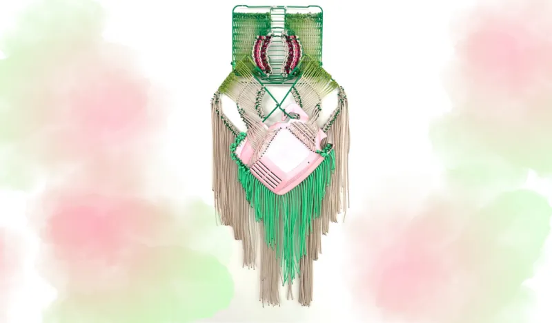 this is a photo of a handwoven green and pink macrame hanging art piece, created by artist, Liz Miller. 