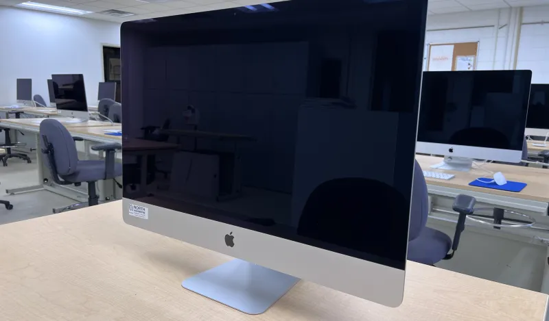 this is a photo of an iMac computer sitting on a desktop in a classroom on-campus. 