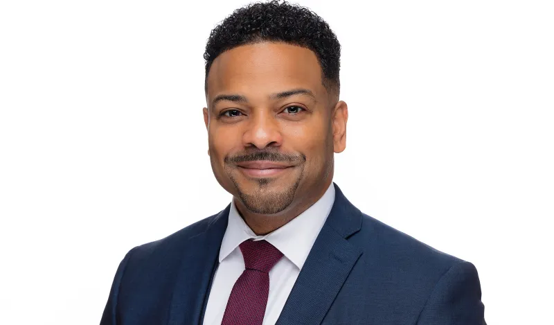 this is a professional headshot photo of Vice President of Student Affairs and Enrollment Management, Julio Vargas-Essex. 