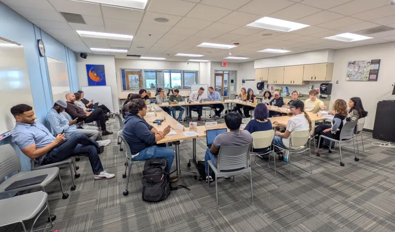 Room image of full senate meeting in CC244 where college leadership and students in discussion