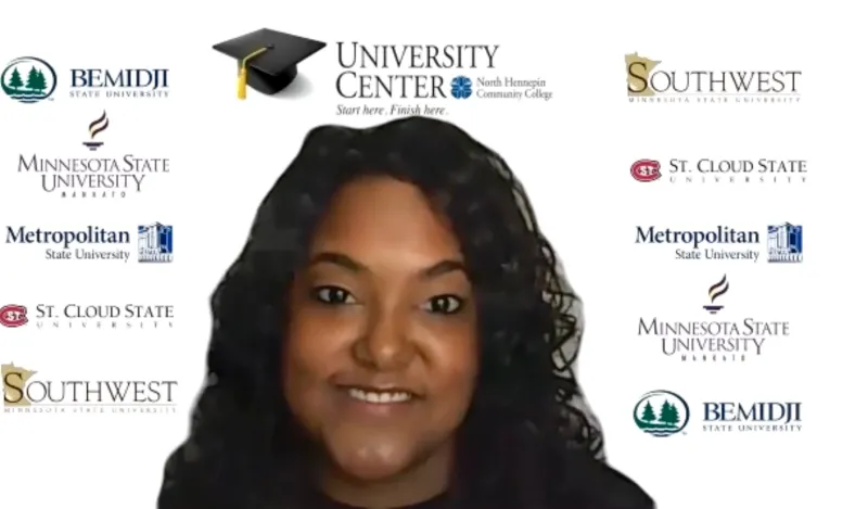 woman smiling in front of wall of university logos 