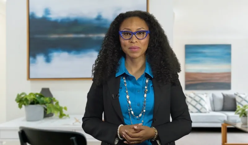 Woman wearing glasses speaking