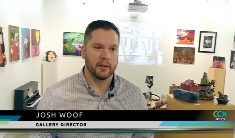 man speaking in an art gallery 