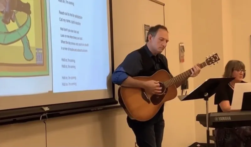 NHCC music faculty, Gary Ruschman playing guitar and Heather MacLaughlin playing piano 