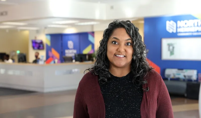 woman smiling on a college campus 