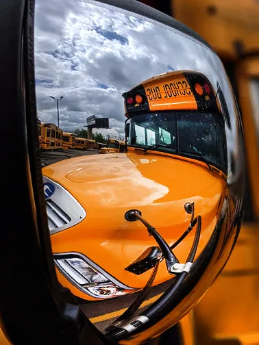 abstraction digital photography by Mickenzi Bitzer of the reflection of a yellow school bus taken through its side mirror