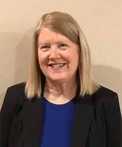 woman in blue shirt smiling 