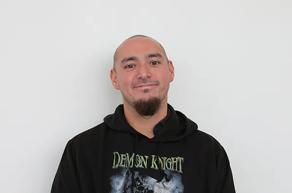 male student smiling with a white background