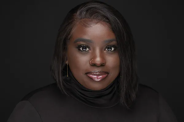 woman smiling with a dark background