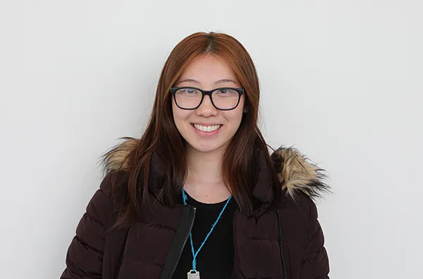 female student smiling with a white background