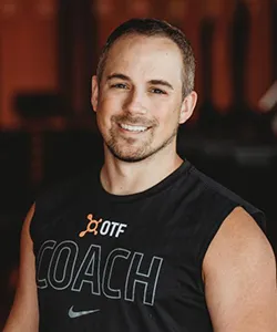 man smiling in sleeveless shirt